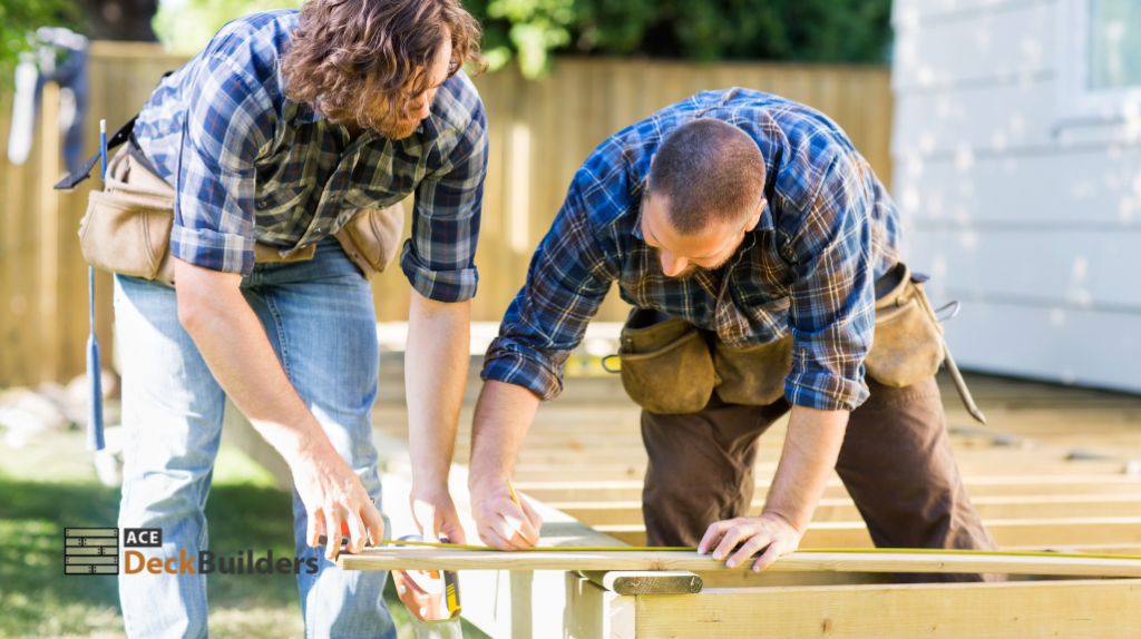 two people measuring deck boards