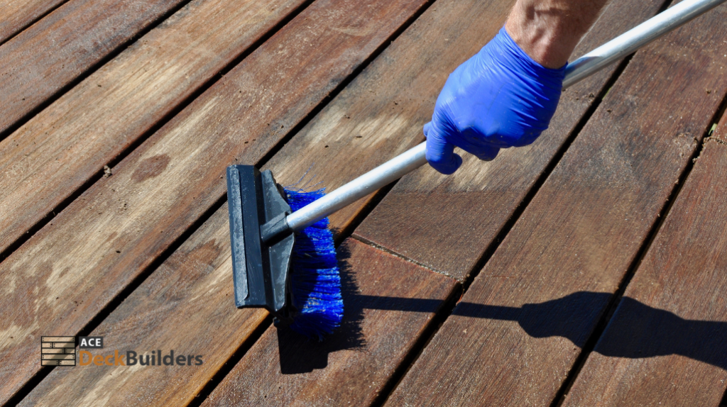 person sweeping wooden surface